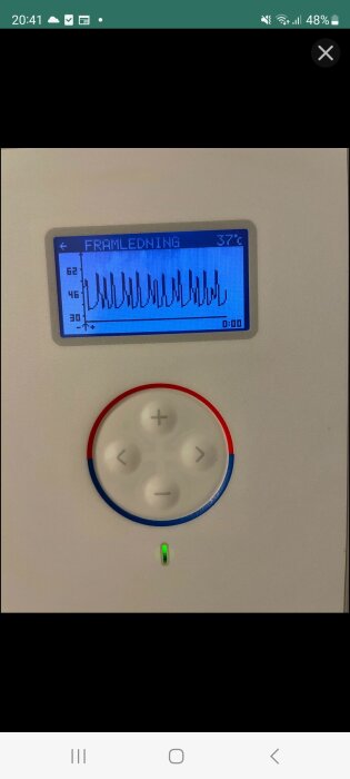 Temperaturdisplay med graf på pumpens inställningar och knappanel med plus, minus, vänster och höger, samt lysande grön indikator.