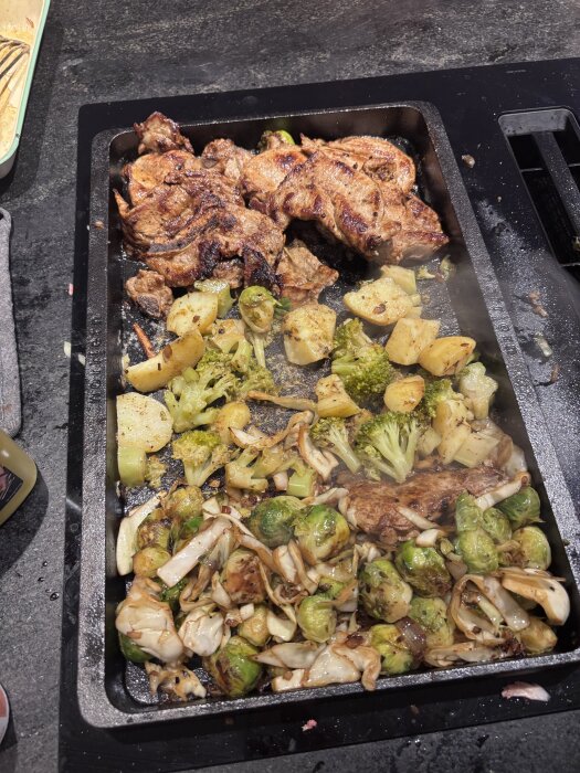 Stekhäll i gjutjärn med kyckling, potatis, broccoli och brysselkål som tillagas jämnt.