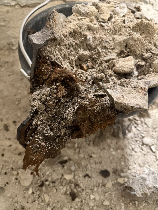 Igensatt avloppsrör med smuts och avlagringar, borttaget från badrumsprojekt för att förbättra vattenflödet i duschen.