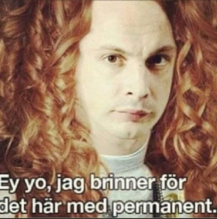 En person med långt, lockigt rött hår och en humoristisk text om deras frisyr i bildens nedre del.