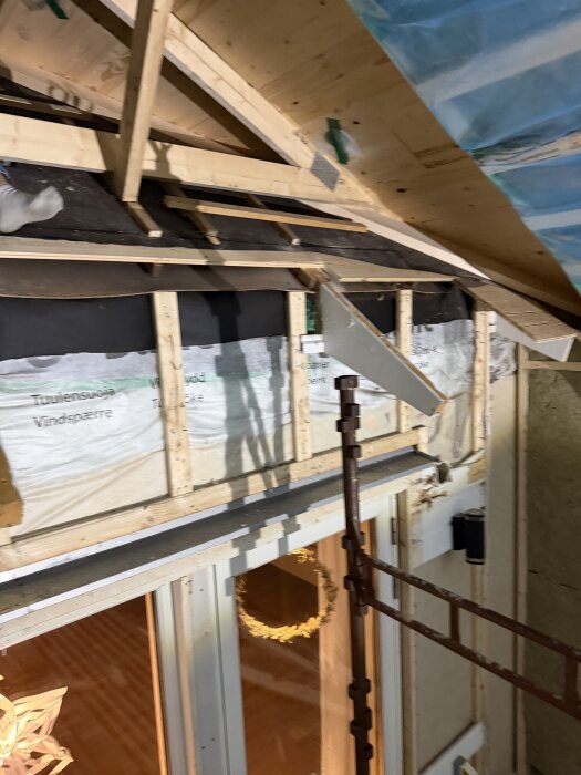 Tillbyggnad av tak med träreglar och isolering. Luftspalten diskuteras i relation till fukt och mögelskydd.