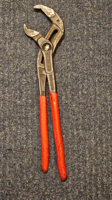 Tångverktyg Knipex Cobra XL med röda handtag, fotograferad mot en grå yta. Säljs för 200 kr, normalt pris 559-1000 kr.
