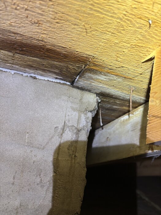 Tak och vägg i ett hus med misstänkt läcka, synliga fuktskador efter ihållande regn, söker lösning för tätning.