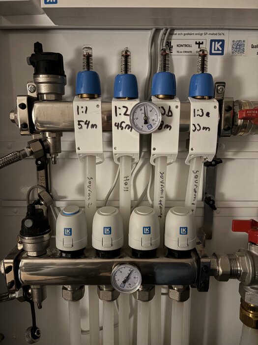 Golvvärmesystem med fyra ventilinställningar och LK-logotyp, där vänstra ventilens flöde är max öppet, vilket orsakar överhettning i rummet.