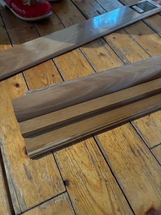 Trösklar staplade på ett trägolv, med en nivålist ovanpå för att öka höjden som en del av en bygglösning.