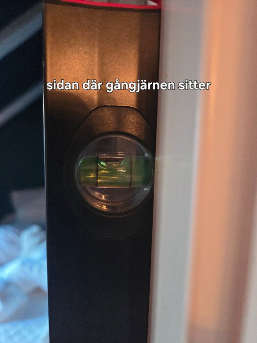 Vattenpass mot dörrkarm som visar att det lutar något; fråga om justering med karmskruv eller kapa dörrbladets topp.