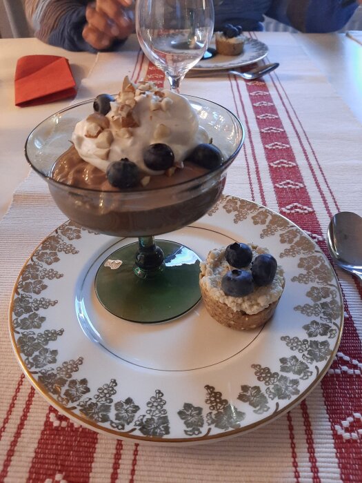 Efterrätt bestående av chokladmousse och Key lime pie med blåbär på dekorerad tallrik.
