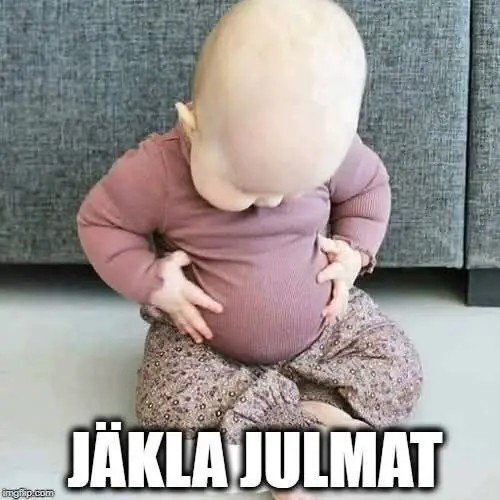 En bebis sitter på golvet och tittar ner på sin mage. Texten "JÄKLA JULMAT" är under bilden.
