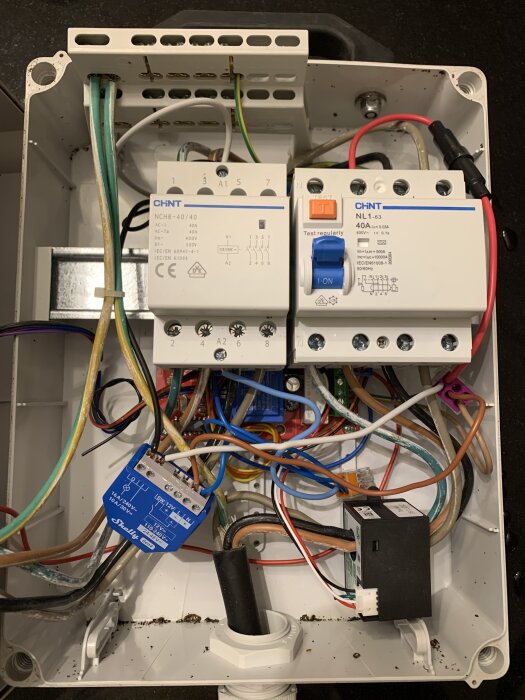 Elinstallation för bilens laddbox med kontaktor, jordfelsbrytare och olika kablar, inklusive en Shelly-enhet för styrning.
