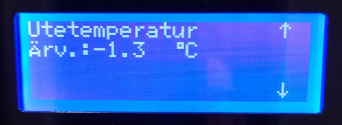 Temperaturskärm visar utetemperatur -1.3°C med uppåt- och nedåtpilar på en REC Temovex RT Blue. Skärmen är blå med vit text.