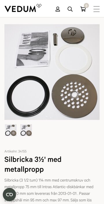En silbricka med metallpropp, centrumskruv och packningar för diskbänkar, med instruktioner tillhörande.