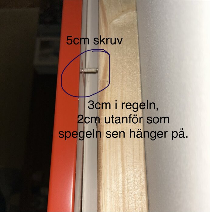 Skruv på 5 cm där 3 cm är inskruvat i en träregel och 2 cm sticker ut för spegelupphängning.
