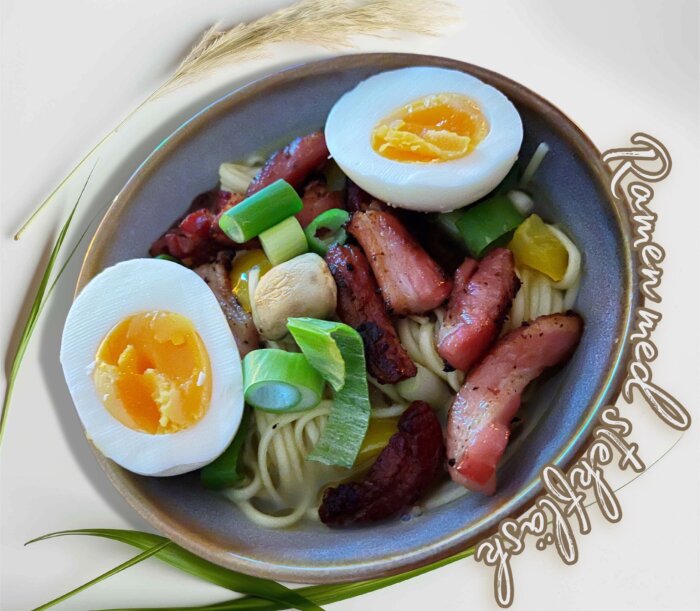Skål med ramen innehållande stekfläsk, champinjoner, böngroddar, salladslök, paprika, ramennudlar och kokt ägg.
