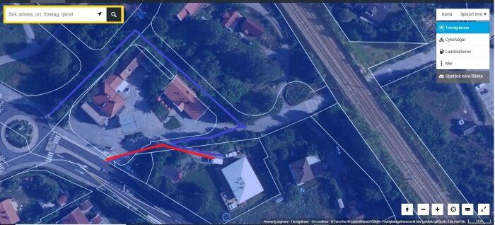 Flygbild över ett område där den gamla utfarten är markerad med en röd linje och den nya utfarten med en blå linje.