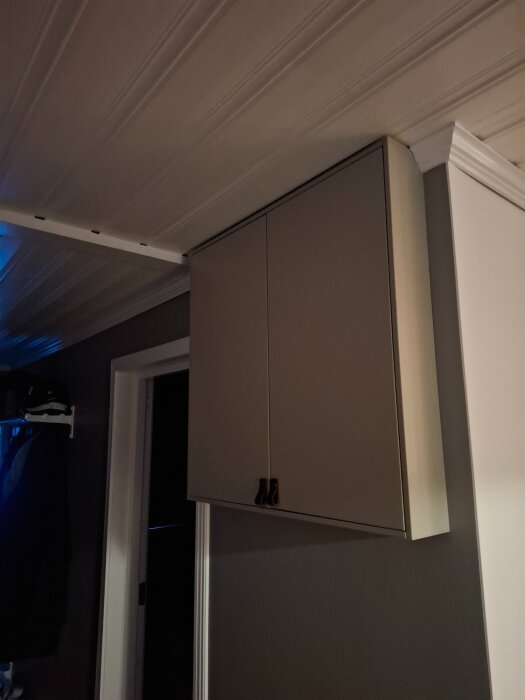 Väggmonterat skåp från Ikea med dörrar stängt i ett rum, anpassat för att rymma två proppskåp.
