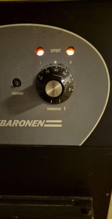 Pannkontroll av Värmebaronen med termostatinställning. Effektratt visar runt 50 grader, två lysande dioder indikerar pågående funktion.