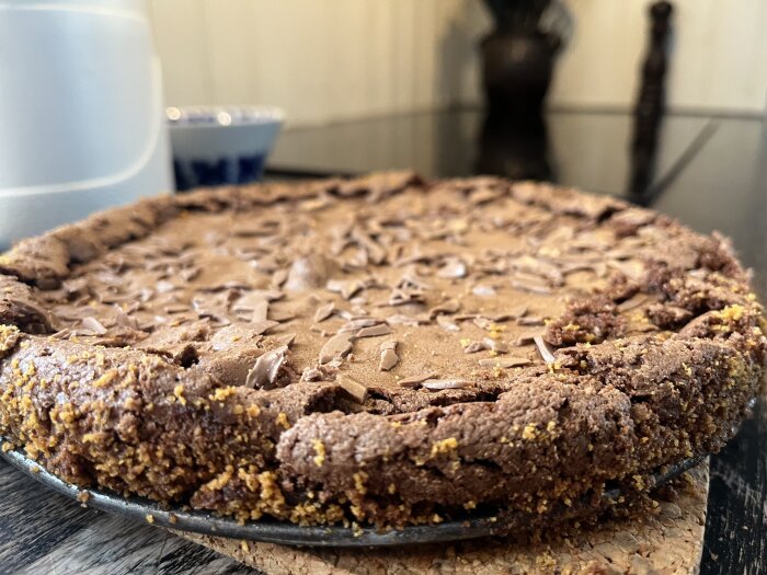 Kladdkaka på ett bord, toppad med riven choklad.