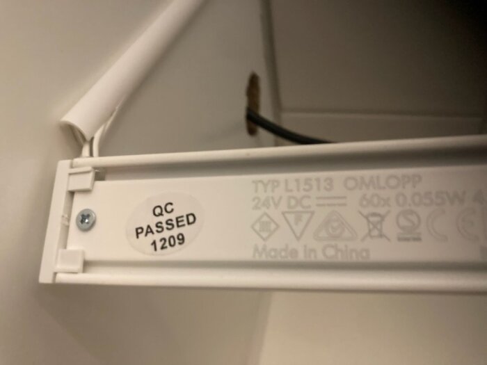 Närbild på IKEA Omlopp köksbelysning med etikett som visar modelltyp L1513 och QC-passering.
