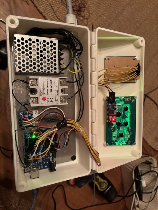 Styrbox med Arduino och elektroniska komponenter, öppnad för att visa kretsar och kopplingskablar.