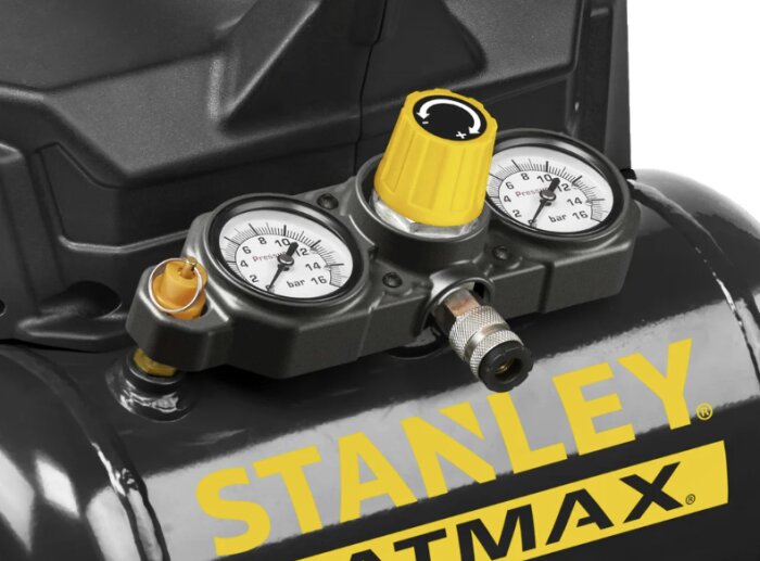 Närbild på en Stanley Fatmax luftkompressor med två manometrar och en gul tryckratt, samt en tryckventil.