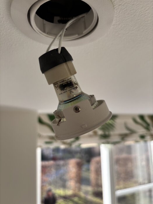 Upphängd dimbar LED GU10-spotlight i tak med brunfärgad glasinsida, tecken på kortslutning och möjlig smält plast.