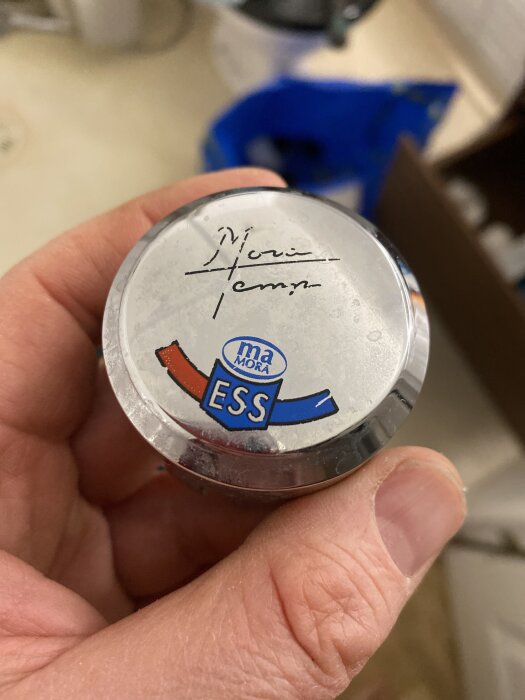 Närbild på en hand som håller i en duschblandare från Mora ESS med texten "Mora Temp".
