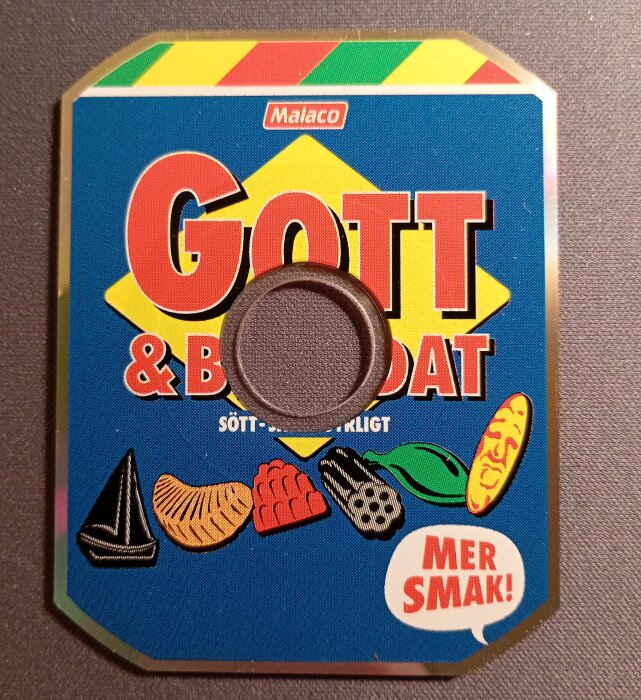 Rektangulär reklam-CD med texten "Gott & Blandat" och godisillustrationer mot en blå bakgrund.