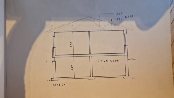 Sektion av ett hus visande takstolens placering och dimensioner, klart markerade med mått och vinklar.