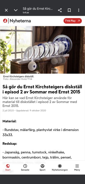 Tallriksställ med vita och blå tallrikar framför ett fönster, omgivet av växter.