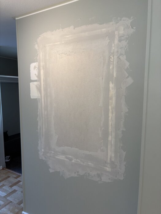 Gipsskiva med spacklade skarvar där ett fönster tidigare satt i en innervägg; pappremsa syns genom spacklet.