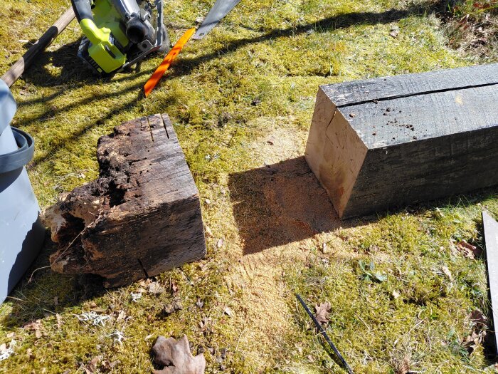 Ruttna och nya trästolpar liggande på en gräsmatta, omgivna av verktyg som används för att reparera en grindstolpe.