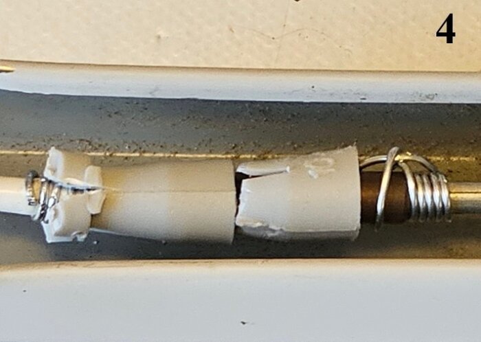 Repairs with plastic plugs wrapped with steel wire and epoxy on a cable end for secure fixing.