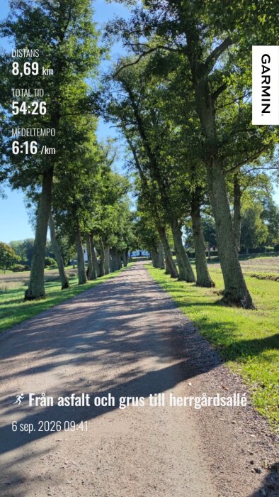Asfalterad väg kantad av träd i en parkmiljö med text som visar löpstatistik från Garmin.