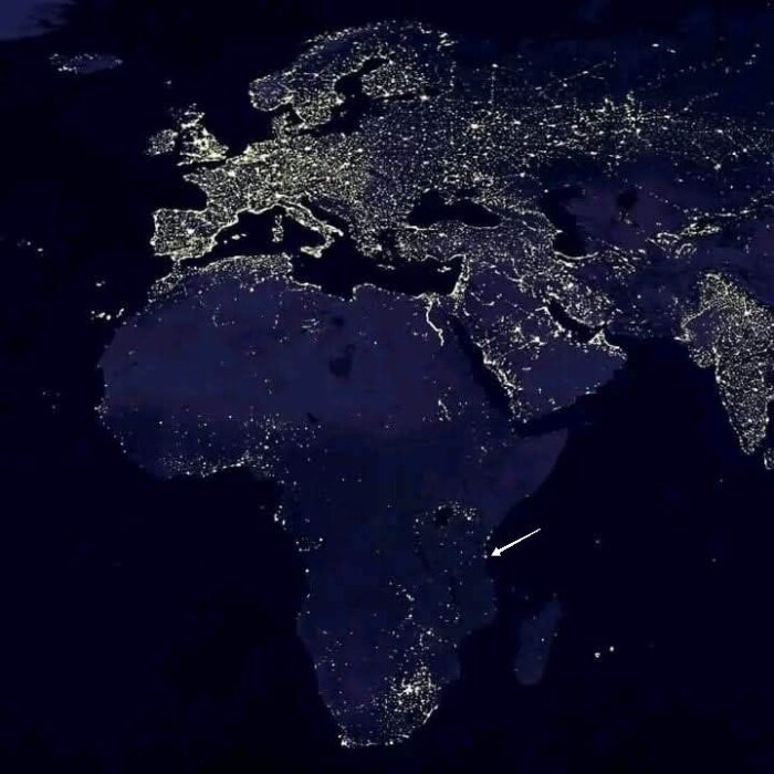 Satellitbild av natten som visar ljusets spridning över Europa och Afrika, med fokus på en pil pekande mot en region i Afrika.
