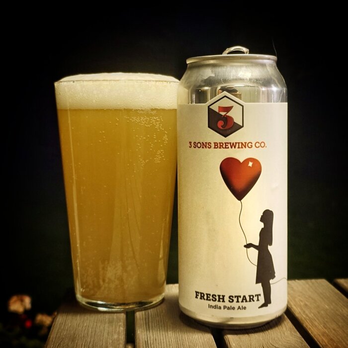 En burk och ett glas med India Pale Ale från 3 Sons Brewing Co., etiketten visar en person med hjärtballong.
