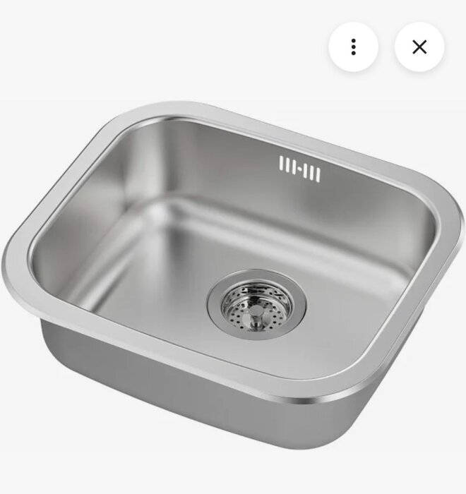Rostfri diskho med avrinningshål, rektangulär form och släta kanter, sedd uppifrån, med matt yta och en rund sil i botten.