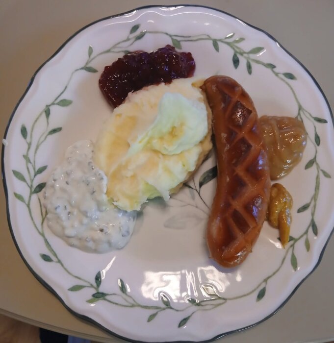 Tallrik med grillad korv, potatismos, lingonsylt, senap och en gräddig sås.