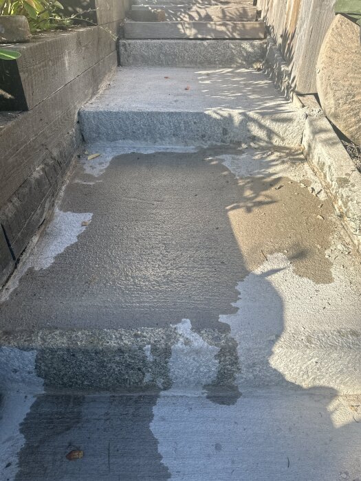 Betongtrappa med rörelsefog avbruten av en board mellan granitblock och gjuten platta, problem uppstår då boarden är svår att ta bort.