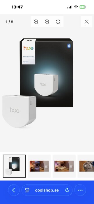 Förpackning och dimmerpuck av Philips Hue Wired Dimmer Switch, visas mot en vit bakgrund och svart ask.
