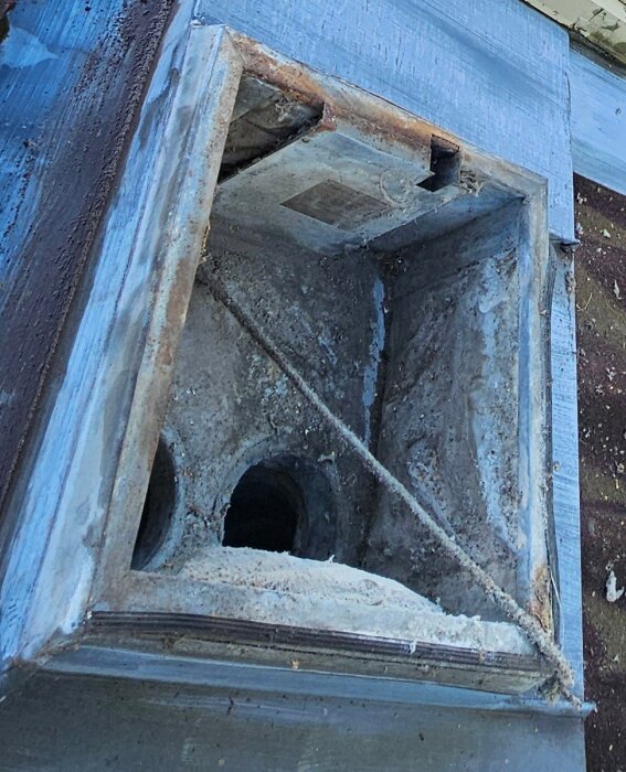 Öppen ventilationskanal på taket med avlägsnade tätningslister, visar möjligt vattenläckage in mot kontaktpunkten för takfläkten.