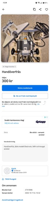 Äldre modell av en handöverfräs med sladd och justerbar bas, placerad på betonggolv.