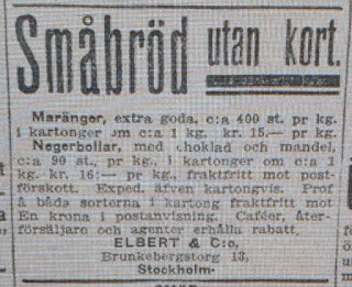 Tidningsannons från 1918 som nämner småbröd, maränger och negerbollar med choklad och mandel, från Elbert & Co, utan kokosflingor.
