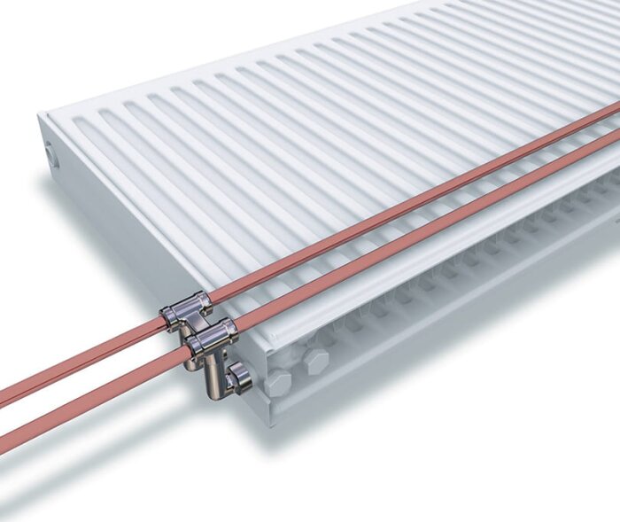 Radiator med TP:s kopplingslösning och rör med ventiler, vit design.
