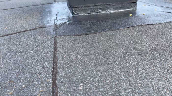 Filmen visar problem med bubblor och en grop på taket som lades om senast 2009. Diskussion om orsaker, som värmepåverkan, och om det behövs en ny takomläggning eller reparation av problemområden.