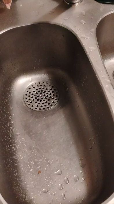 Filmen visar problemet med dålig avrinning i ett kök där vatten fyller diskhoarna. Avloppet fungerar bra när gallret och röret lossas. Se vad som händer när vattnet rinner, trots rena vattenlås under diskhon. Vad kan orsaka problemet?