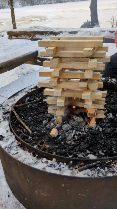 Upptäck hur ved som lagrats utomhus i sex månader brinner i -7°C. Se den effektiva konstruktionen av staplade vedträn skapa en varm och livfull brasa, perfekt för kalla vinterdagar.