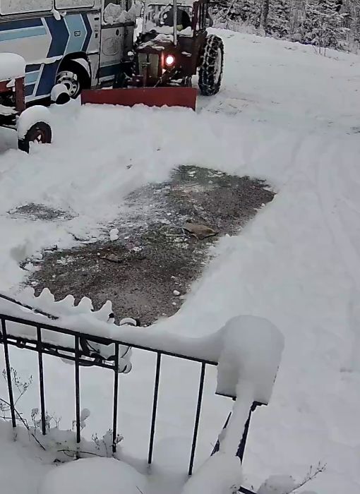 I den här videon visar vi en traktor som används för att skotta snö på en uppfart. Trots en kommentar om situationens humoristiska aspekt, ser traktorföraren till att få jobbet gjort effektivt. Perfekt exempel på maskinkraft i vinterväder.